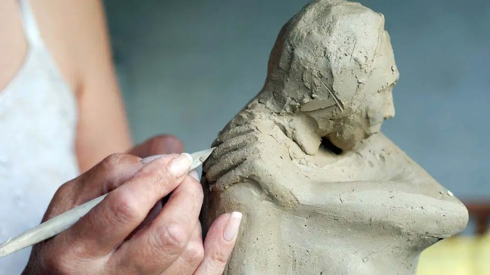 Artist creating a timeless sculpture.