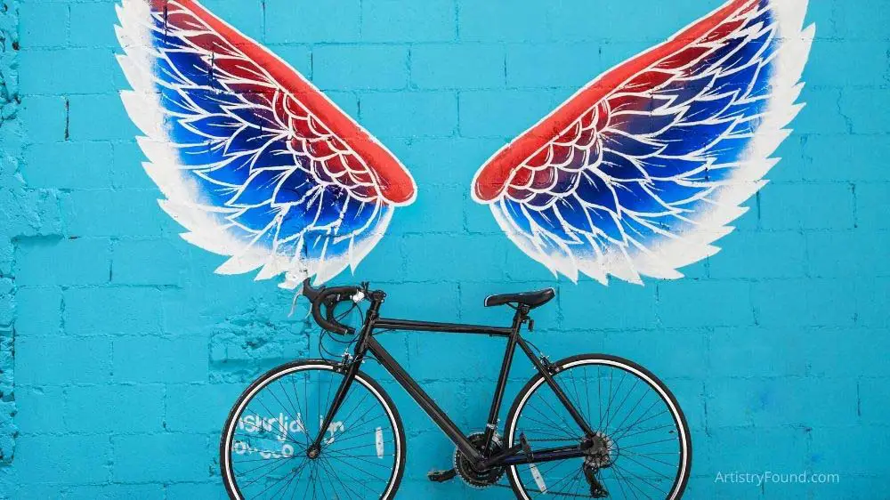 Angel wings and bicycle street art.